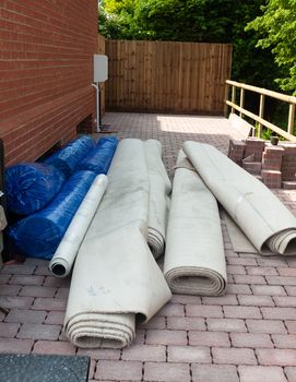 rolled up construction materials outside new house on floor; England; UK