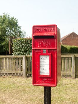 rural red royal mail box rustic outside street village; England; UK