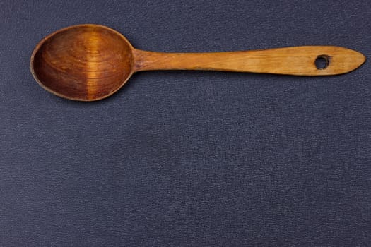 a wooden spoon on the black background