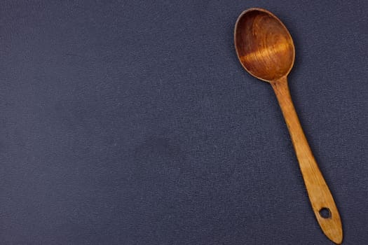 a wooden spoon on the black background