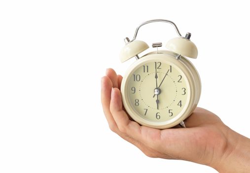 Hand holding retro alarm clock with white background