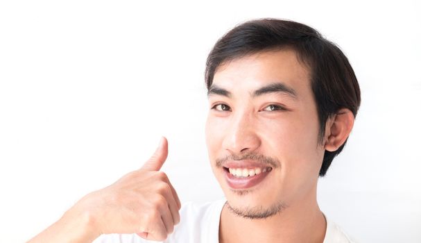 Closeup asian man showing thumbs up with white background, excellent symbol