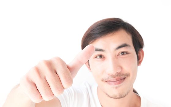 Closeup asian young man showing thumbs up with white background, excellent symbol