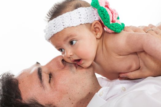 Father kissing his four months old baby girl
