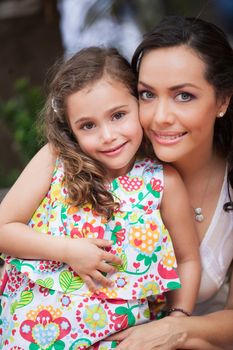 Mother and her young daughter looking at the camera