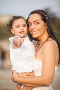 Mother and her baby girl dressed in white