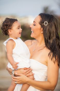 Mother and her baby girl dressed in white