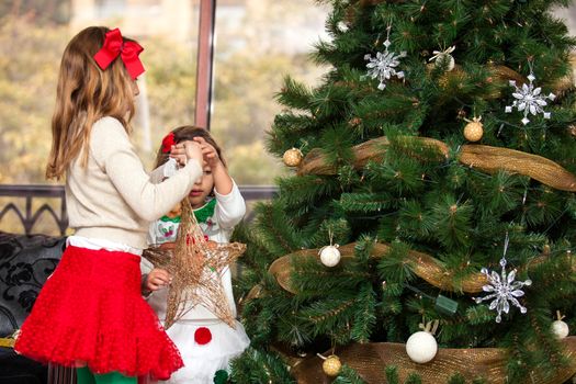 Sisters decorating the Christmas tree