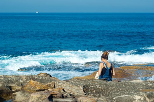 young woman against the blue sea