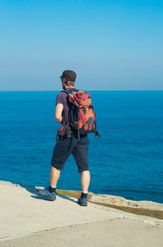 Backpacker boy traveler walk on bondi beach, Sydney, Australia.