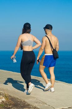 Couple exercise along the beach