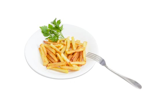 Serving of the French fries with twigs of the parsley on the white dish and fork on a light background
