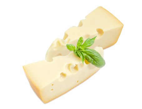 Two pieces of the Swiss cheese with cheese's eyes decorated with twig of the green basil on a white background
