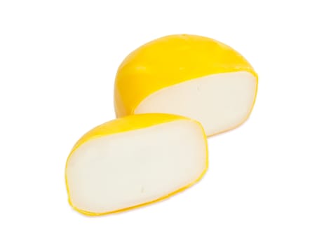 Small wheel of the Dutch firm goat cheese cut into two parts on a white background
