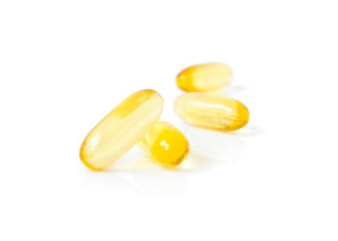 Closeup fish oil capsules on white background, health care and medical concept