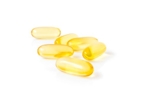 Closeup fish oil capsules on white background, health care and medical concept