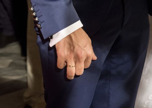 young groom with the wedding ring during ceremony