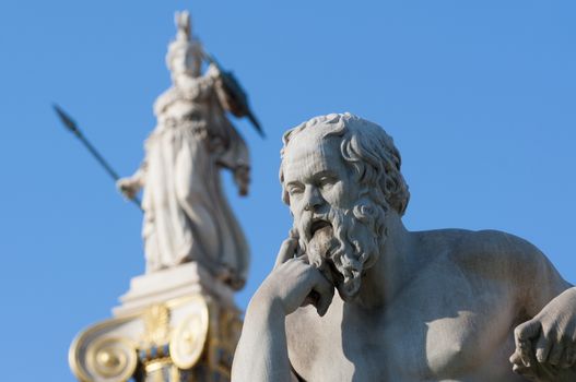 classical statue of Socrates from side with athena statue above and back