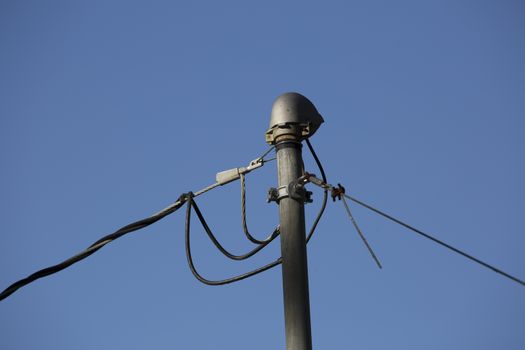 Close up of electrical lines against the deep blue sky