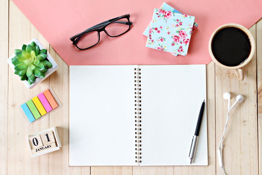 Business, weekend, holiday or new year planning concept : Top view or flat lay of open notebook paper, accessories, cube calendar and coffee cup on wooden background, ready for adding or mock up