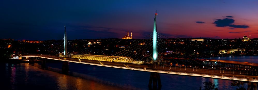 Golden Horn metro bridge illuminated at night in Istanbul, Turkey