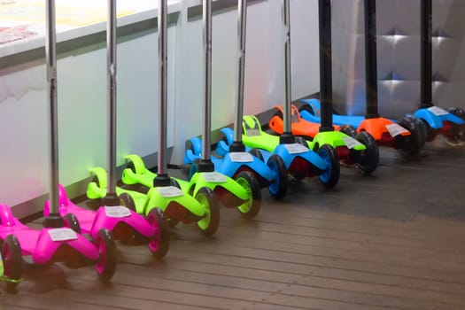 colorful kick scooters in the store window