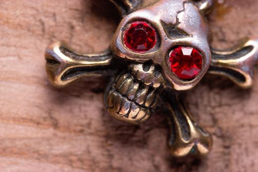 close up of metal skull with red eyes. pirate concept