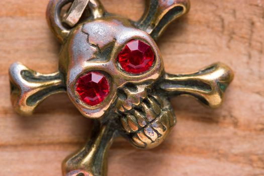 close up of metal skull with red eyes. pirate concept