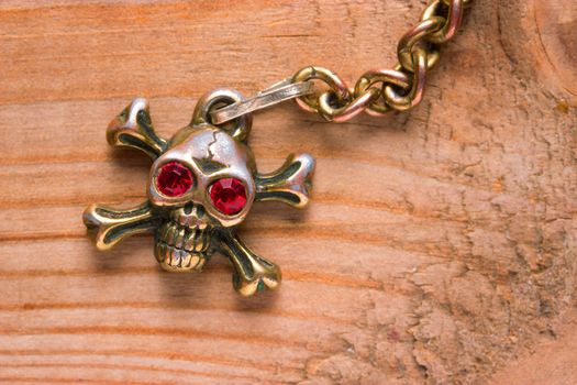 close up of metal skull with red eyes. pirate concept