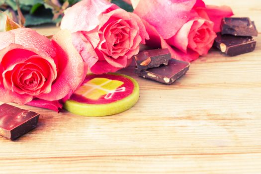 pink roses and sweets on table. copy space