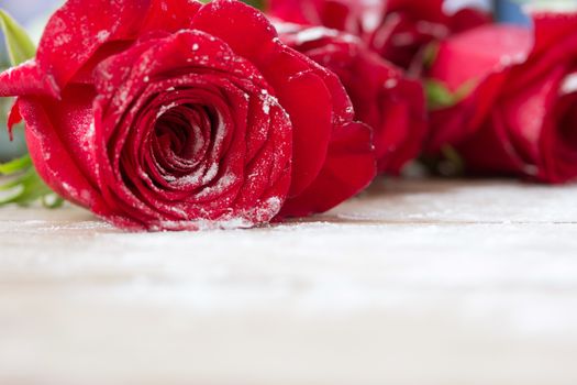 beautiful red color roses on wooden table