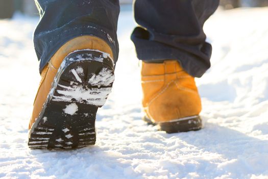 men legs in shoes for extreme tourism. winter. blurred