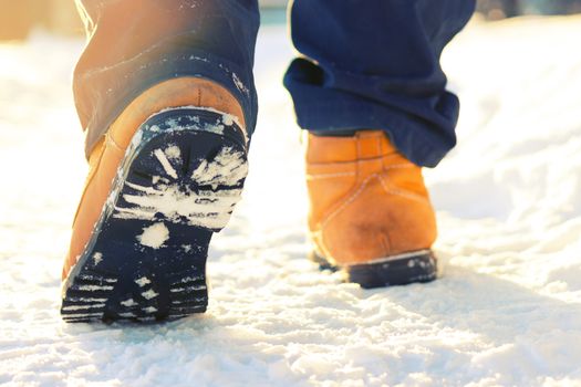 men legs in shoes for extreme tourism. winter. blurred