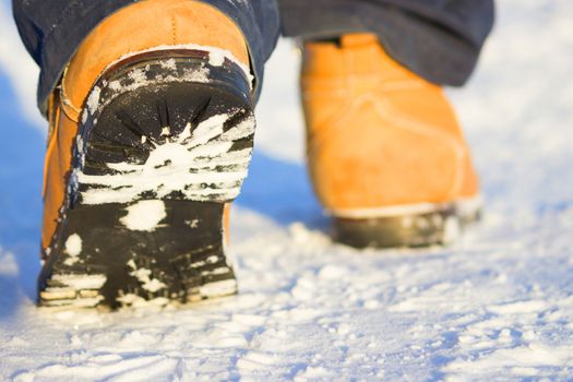 men legs in shoes for extreme tourism. winter. blurred