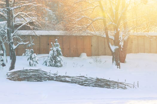 fence covered by snow in village in winter