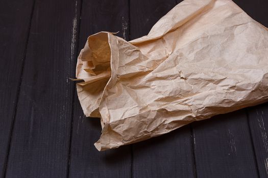 A bag of kraft paper on a black background