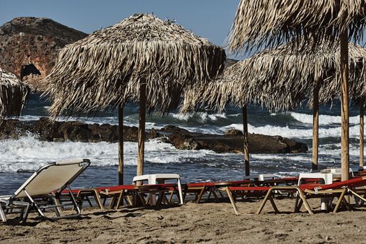 Beds and umbrellas on the beach on the island of Crete, Greece