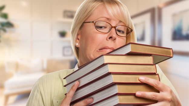 Beautiful Expressive Student or Businesswoman with Books in Office.