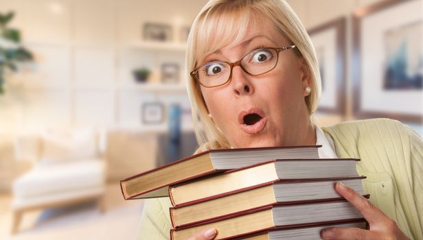 Beautiful Expressive Student or Businesswoman with Books in Office.