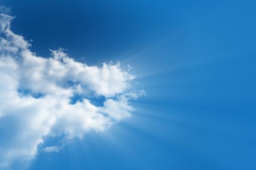 A bright white cloud from which the divine light rays flows in a clear, bright blue sky