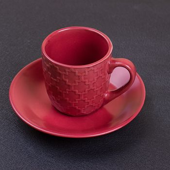 Red coffee cup on the black background