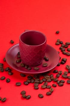 Empty coffee cup and coffee beans on a red background