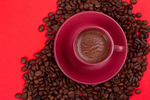 coffee cup with coffee beans on a red background