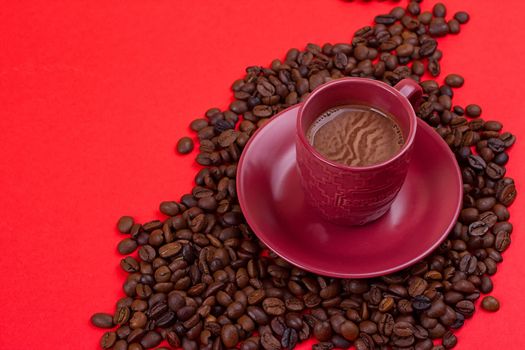 coffee cup with coffee beans on a red background