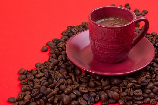 coffee cup with coffee beans on a red background