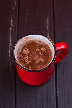 Aromatic cocoa drink. On black rustic background