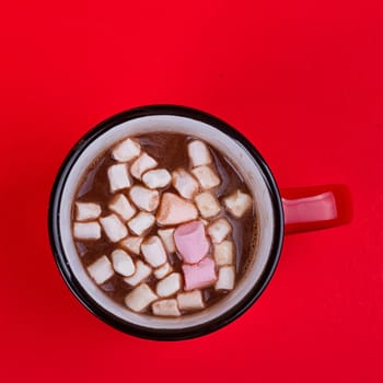 Hot chocolate with marshmallows on the red background