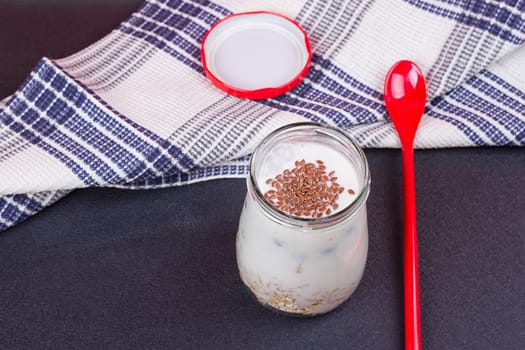 Healthy breakfast - yogurt with blueberries and muesli served in glass jar, Lazy oatmeal