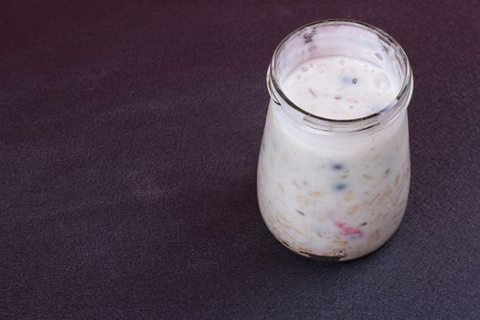 Healthy breakfast - yogurt with blueberries and muesli served in glass jar, Lazy oatmeal