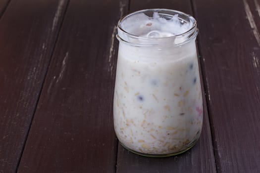 Healthy breakfast - yogurt with blueberries and muesli served in glass jar, Lazy oatmeal